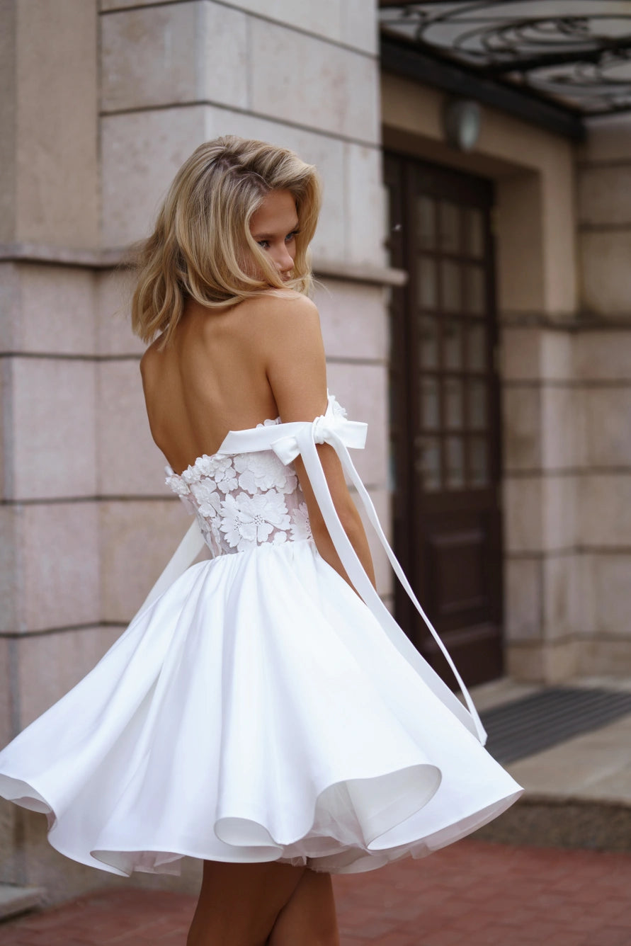 Short wedding dress with a full A-line skirt and dropped straps.